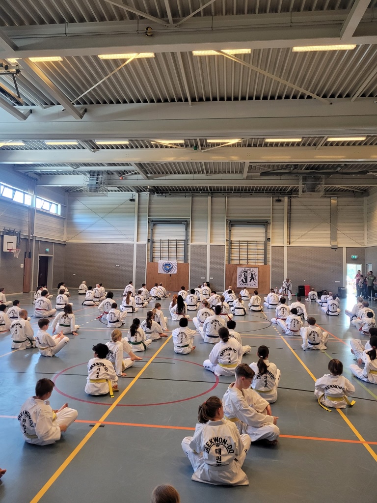circa 120 taekwon doin zitten op de grond en rekken hun spieren tijdens de warming up circa 120 taekwon doin zitten op de grond en rekken hun spieren tijdens de warming up
